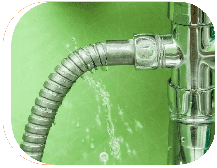 A close up of the water hose on a green wall